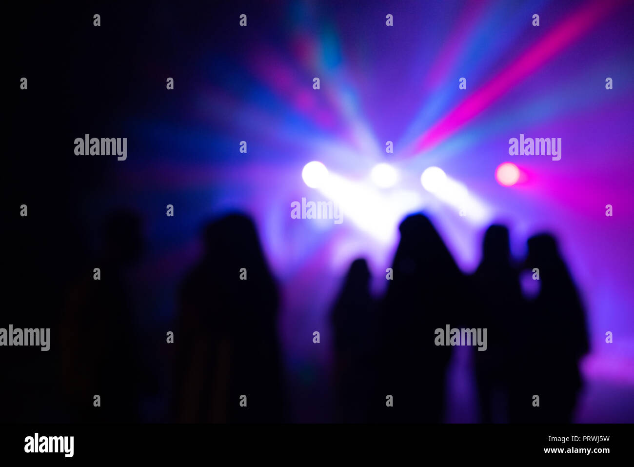 Abstract blurry background, silhouettes of people at open air party Stock Photo