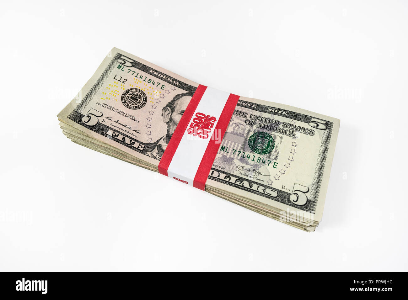 Pack of five dollar bills with $500 paper currency strap. Stock Photo