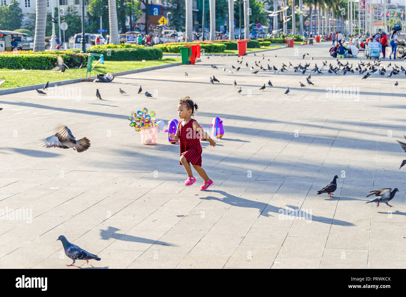 Phnom Penh, Cambodia - April 9, 2018: Preah Sisowath Quay, a riverside public promenade on the bank of the Tonle Sap River with its  large, long open  Stock Photo