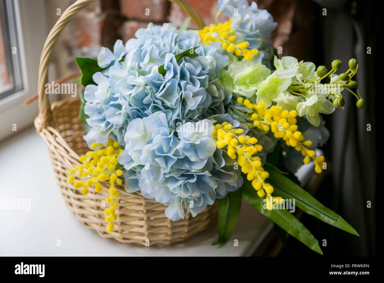 Still life with Bouquet of summer flowers in basket Stock Photo - Alamy