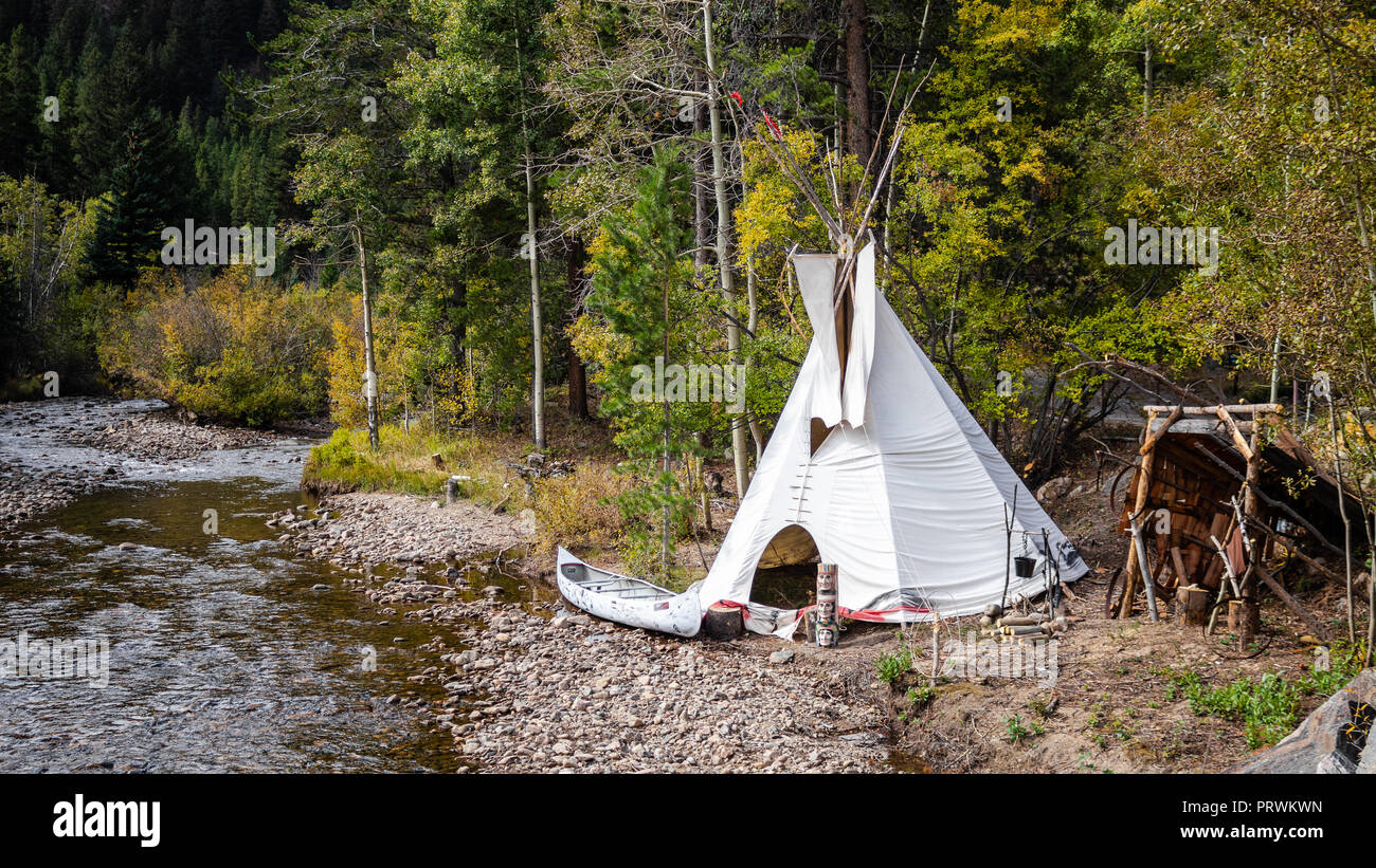 Native American teepee and canoe along side Clear Creek