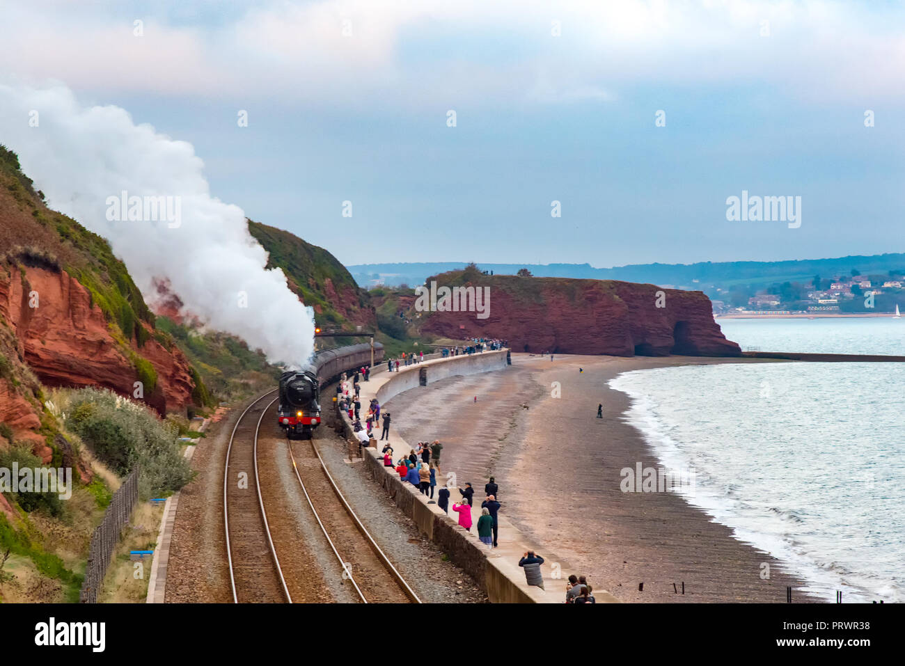 Dawlish, Devon. 4th Oct 2018. UK Weather: The Flying Scotsman on an evening run from Taunton to Plymouth. Seen here passing along the sea wall at Dawlish. The Scotsman is double teamed with Black Five; the locomotive used in Harry Potter movies; to cope with the steep gradients on the Devon Mainline. Credit: Paul Martin/Alamy Live News Stock Photo