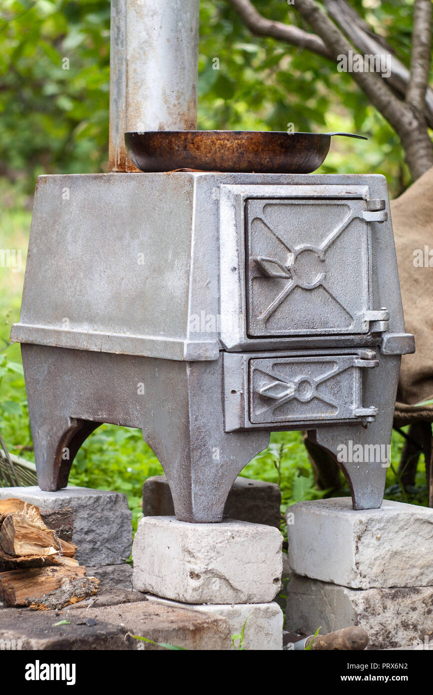 Old Style Cast Iron Wood Stove With Iron Frying Pan On It Standing