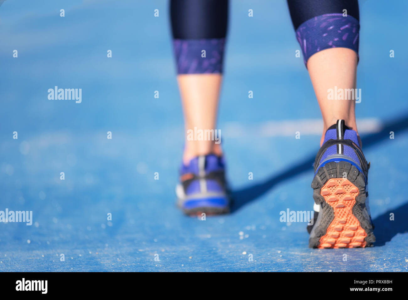 Runner feet running closeup on shoe. woman fitness jog workout welness concept. Stock Photo