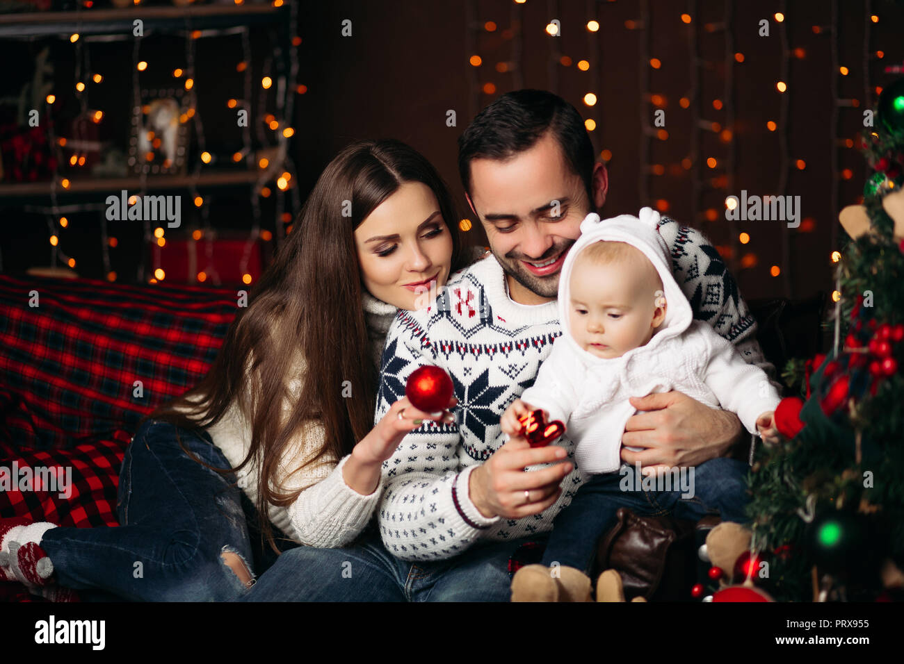 Loving Parents With Baby At Christmas Stock Photo Alamy