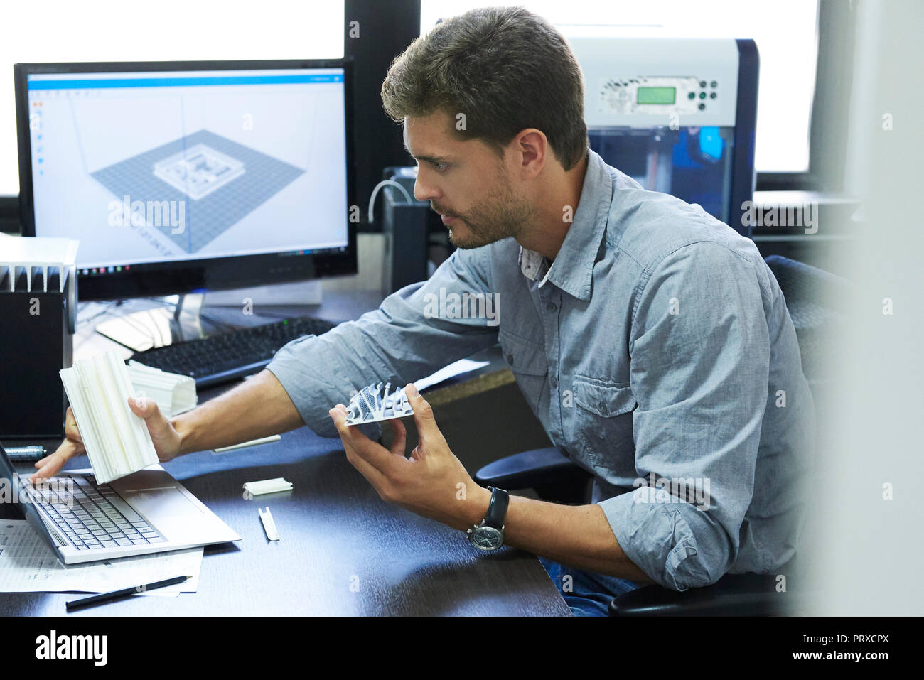 Engineer using laptop in office Stock Photo
