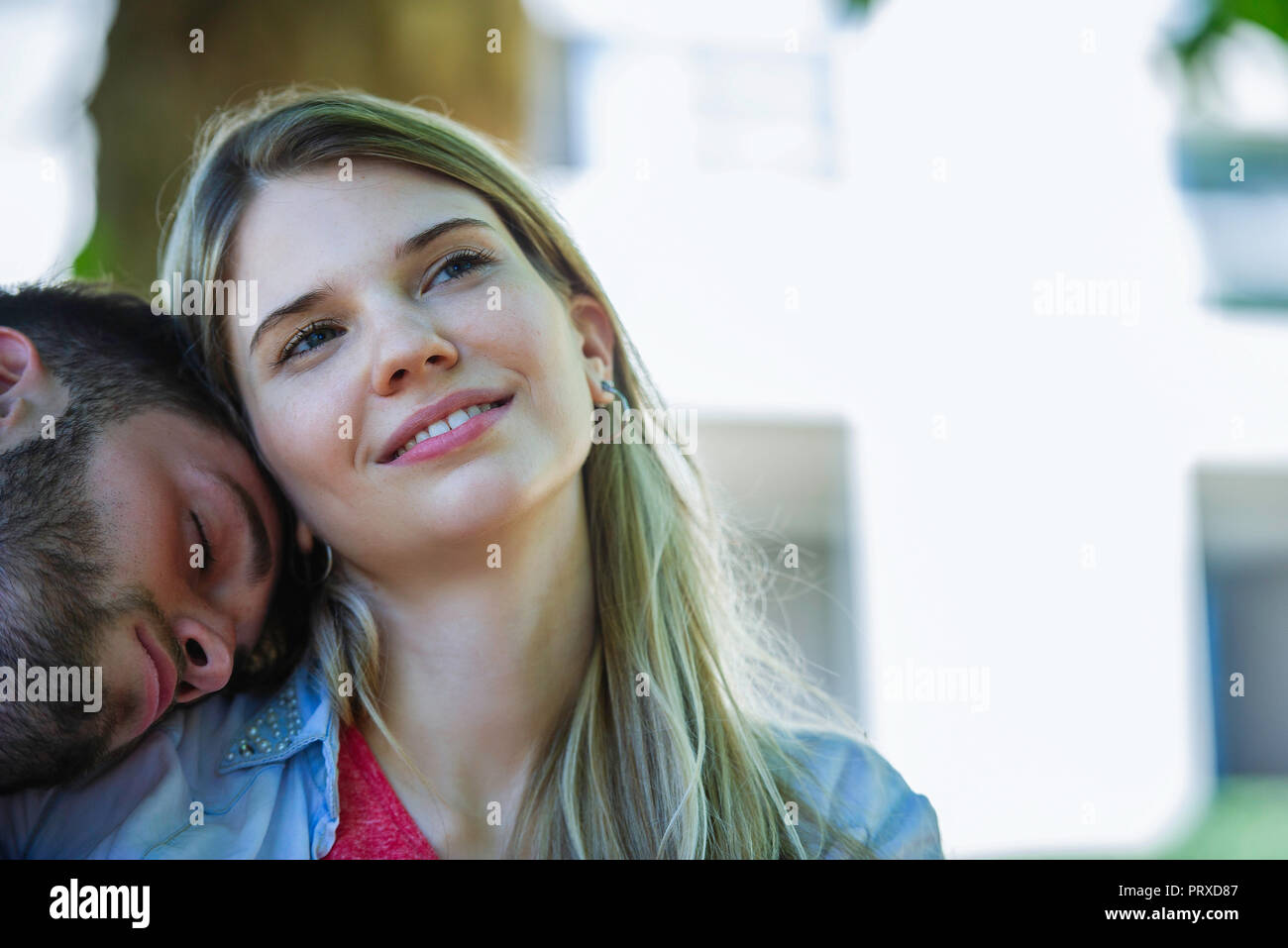 Man relaxing on the woman's shoulder Stock Photo