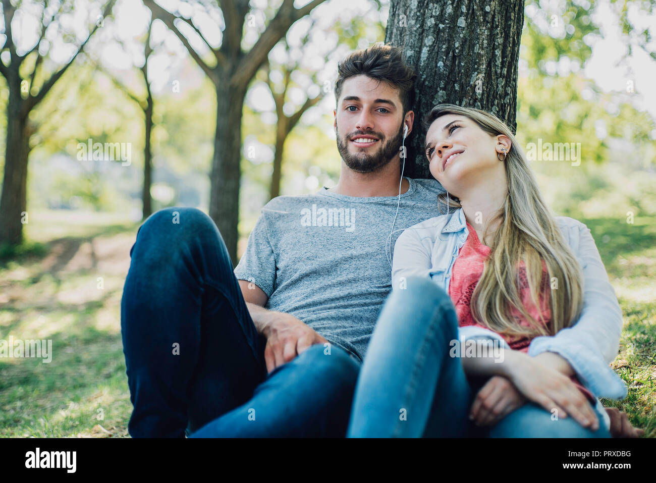 Young couple listening to music on headphones Stock Photo