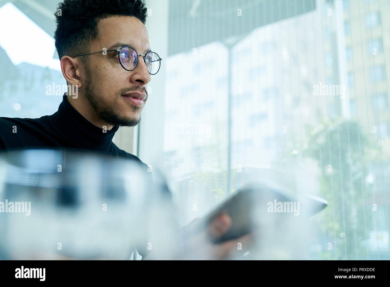 Thoughtful businessman holding digital tablet Stock Photo