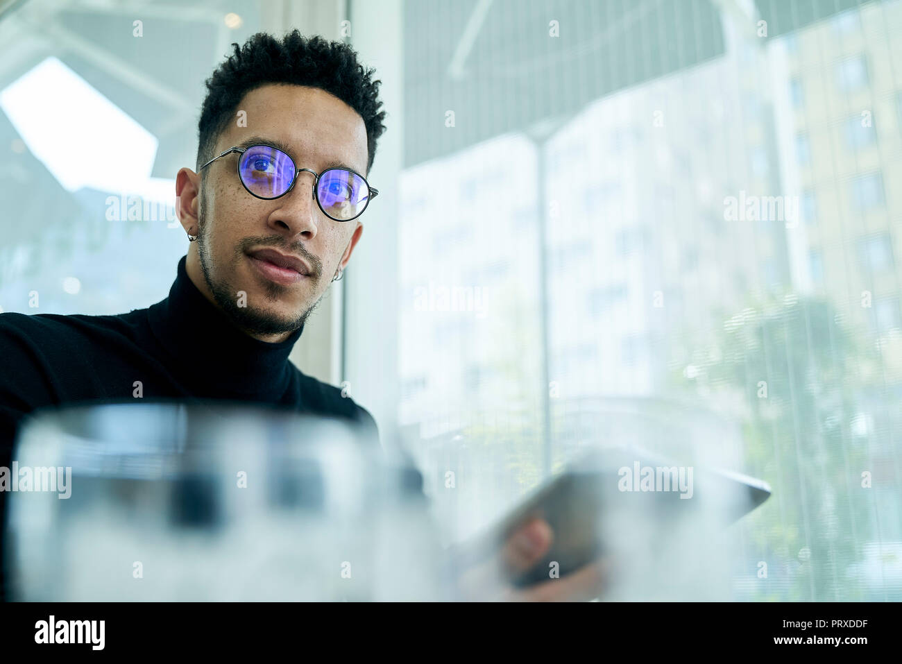 Thoughtful businessman holding digital tablet Stock Photo