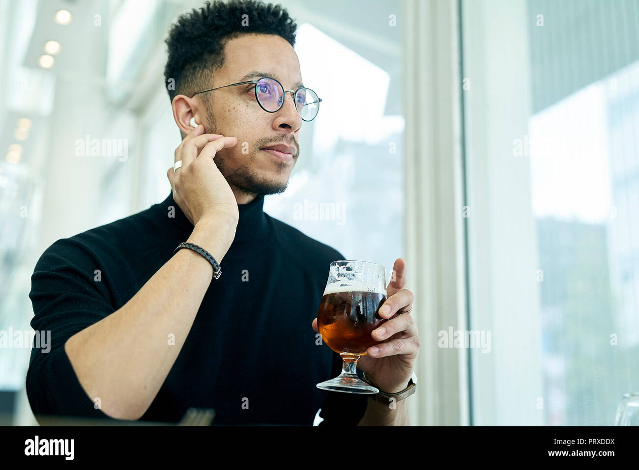 Thoughtful businessman having drink Stock Photo