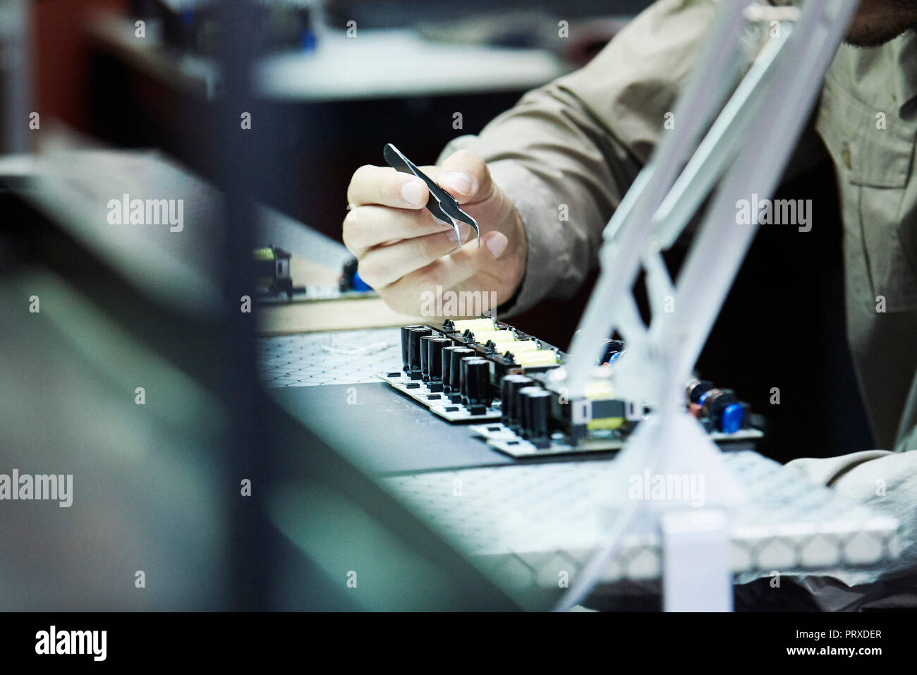 Engineer soldering circuit board in office Stock Photo Alamy