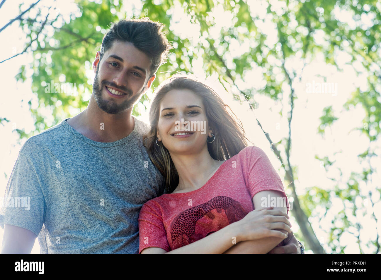 Woman standing in park crossed hi-res stock photography and images - Alamy