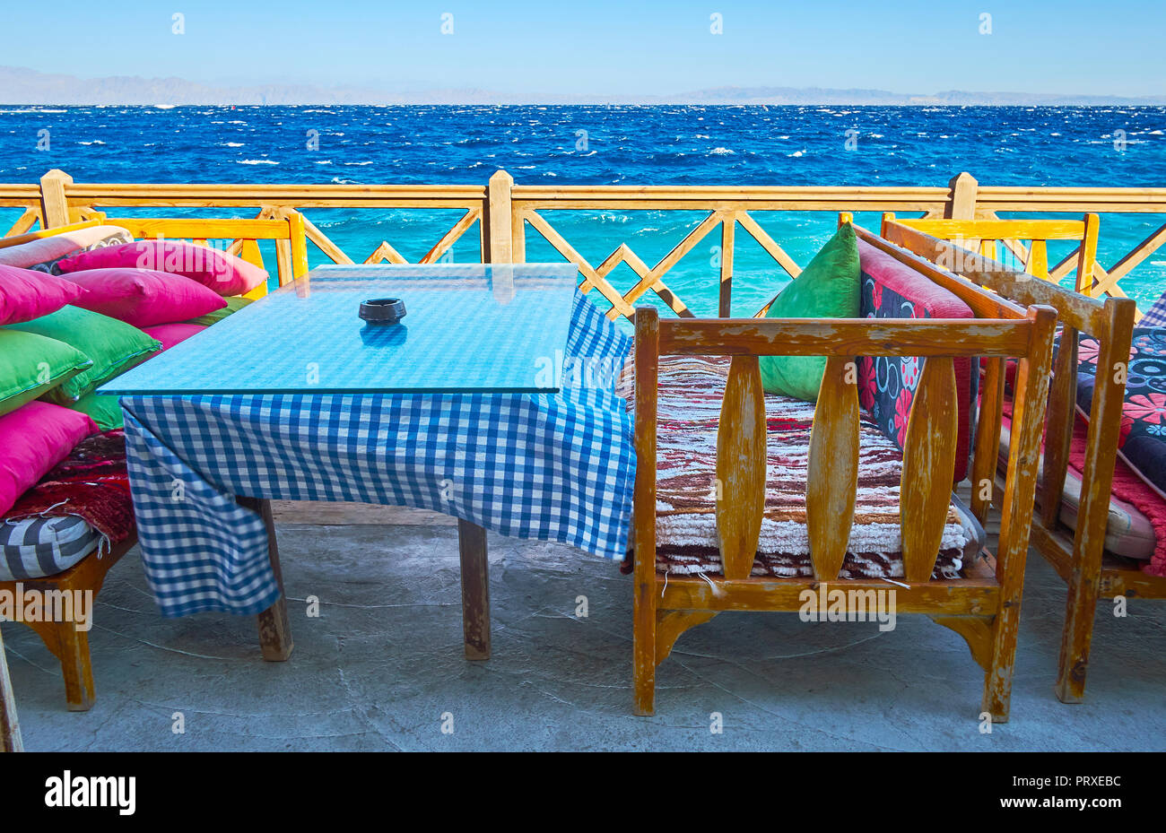 The table of the summer cafe is the perfect place to watch the seascape