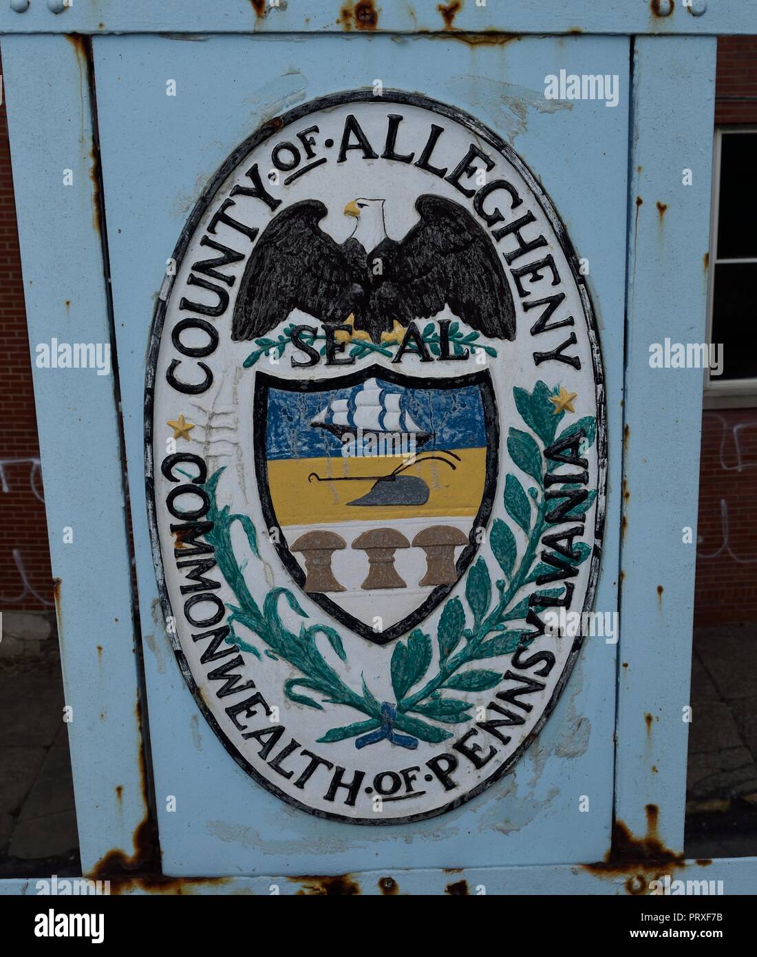 Public art in the form of great seals of the 13 original colonies along with Allegheny County found emblazoned and painted on the 40th Street Bridge Stock Photo