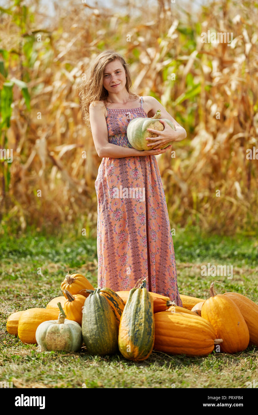 Autumn fairy, beautiful woman in long dress surrounded by pumpkins Stock  Photo - Alamy