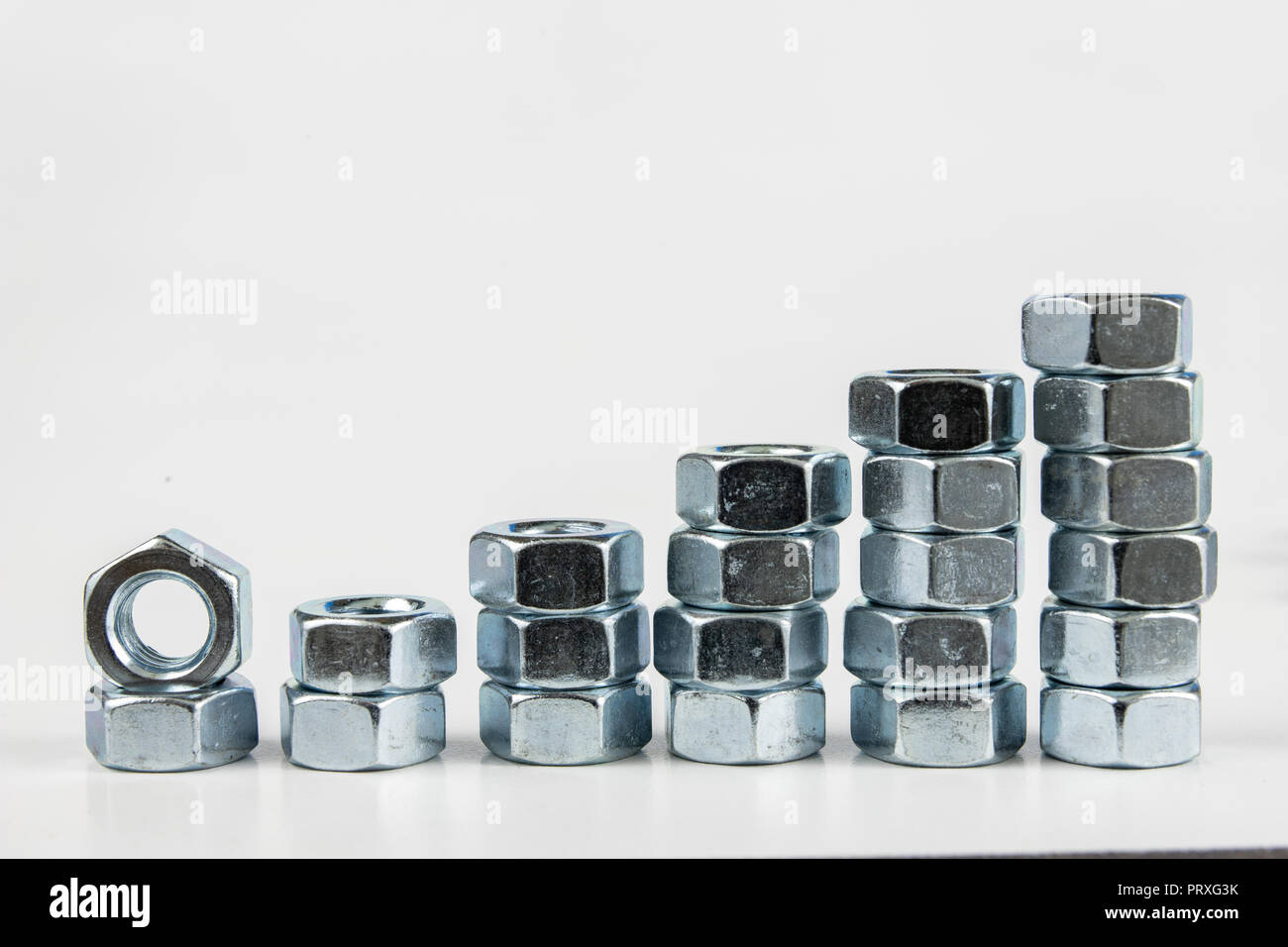 Chrome caps on a white table. Accessories for mounting steel structures on a workshop table. White background. Stock Photo
