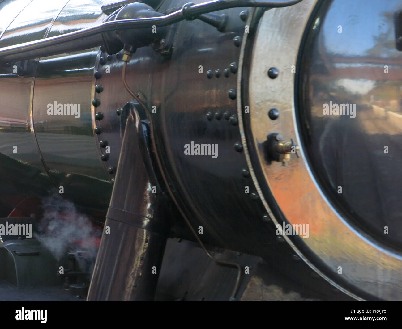 Reflection of the track showing in the shiny front of a black engine ...