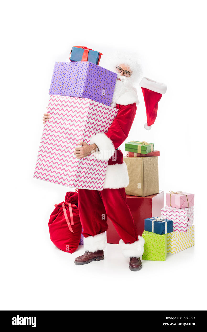 santa claus in eyeglasses holding pile of gift boxes isolated on white ...