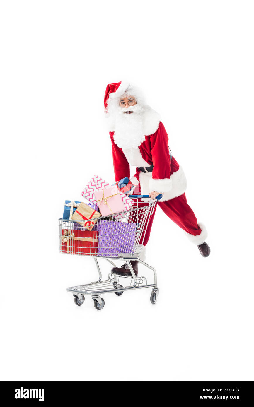 santa claus carrying trolley with pile of gift boxes isolated on white ...
