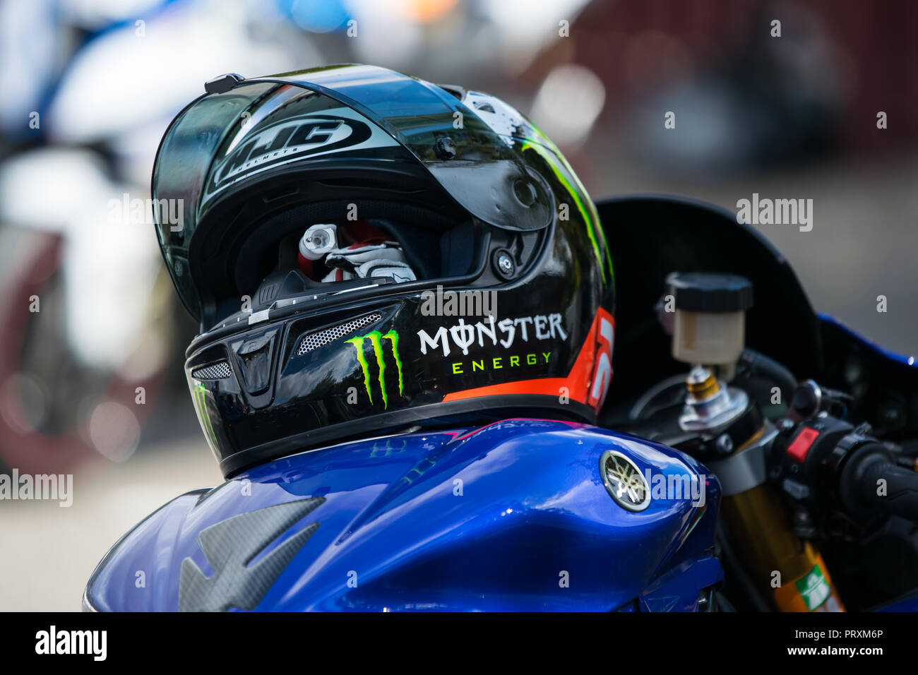 view of the Yamaha r1 motorcycle tank and HJC helm lying on it with the Monster Energy advertisement Stock Photo
