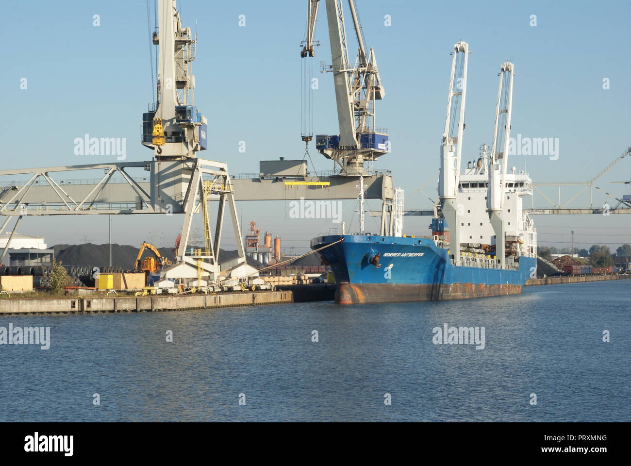 Big ship vessel while loading bulk in Bremen port with crane Stock Photo