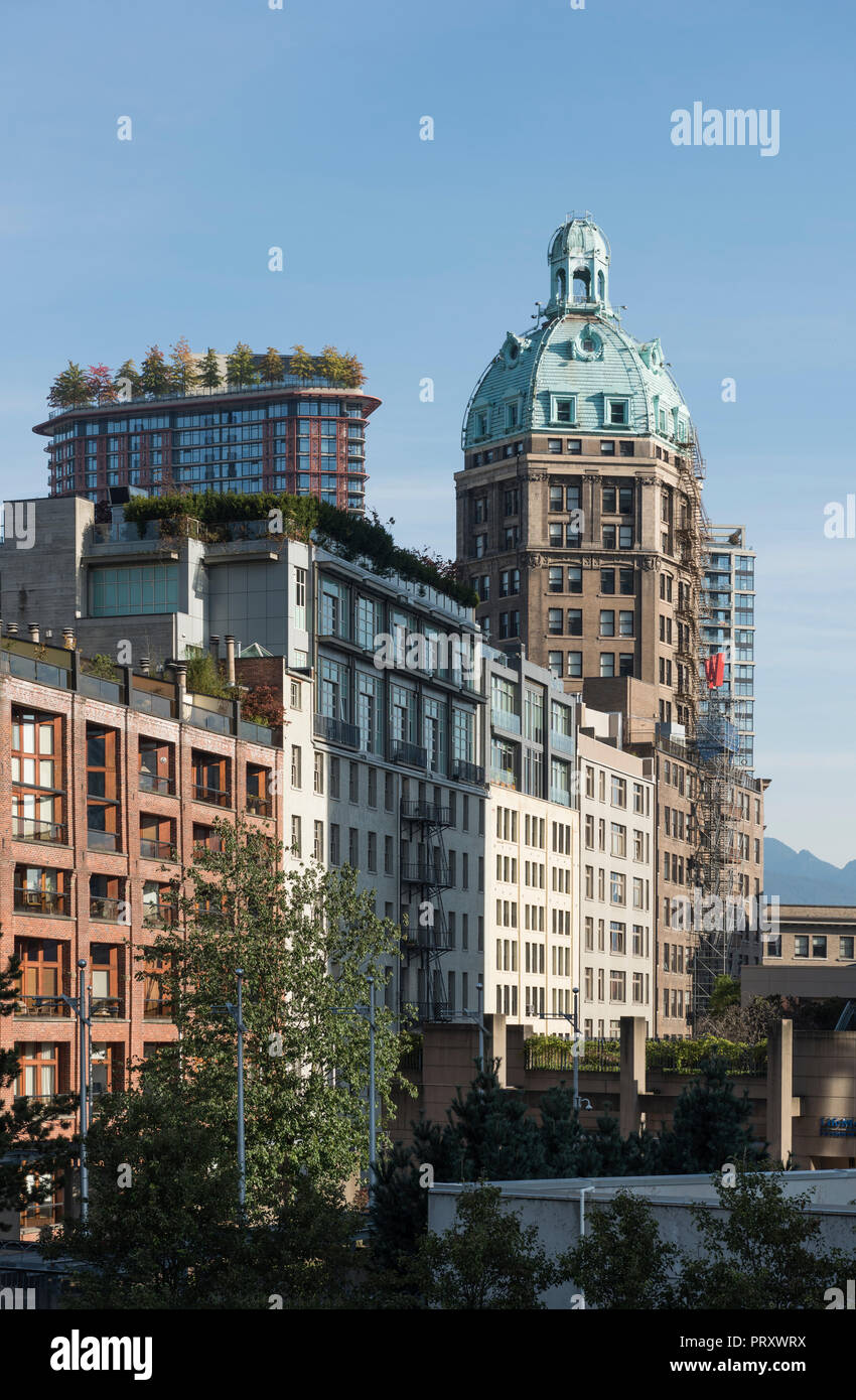 Sun Tower, a heritage building with copper roof protruding past older buildings since renovated as condominiums, Vancouver City Stock Photo