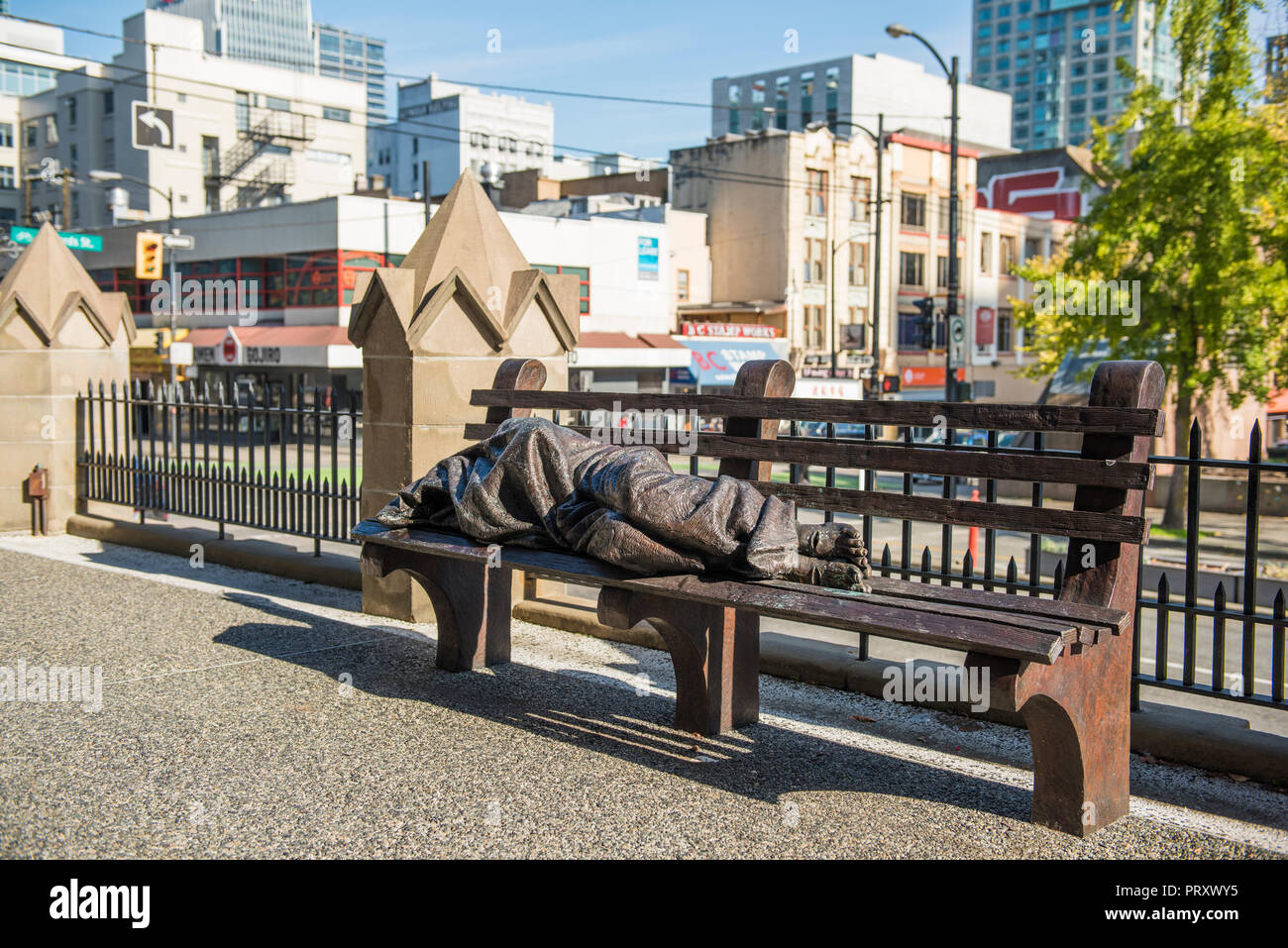 Statue of Homeless Jesus by artist Timothy Schmalz in front of the Holy Rosary Church, Vancouver City. Stock Photo
