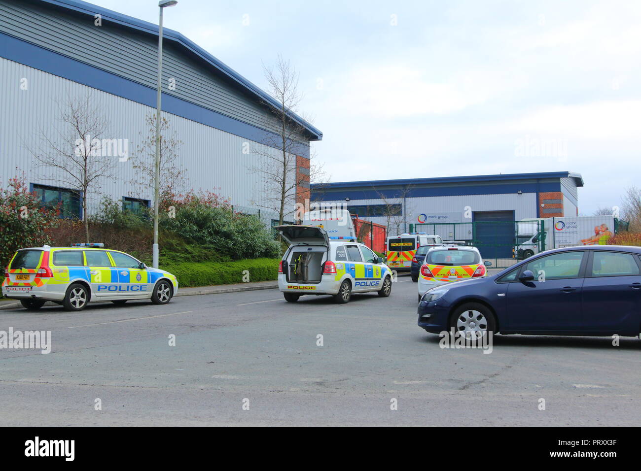 Police vehicles attending a crime scene , where the suspect was thought to be hiding in an industrial area of Garforth,West Yorkshire. Stock Photo