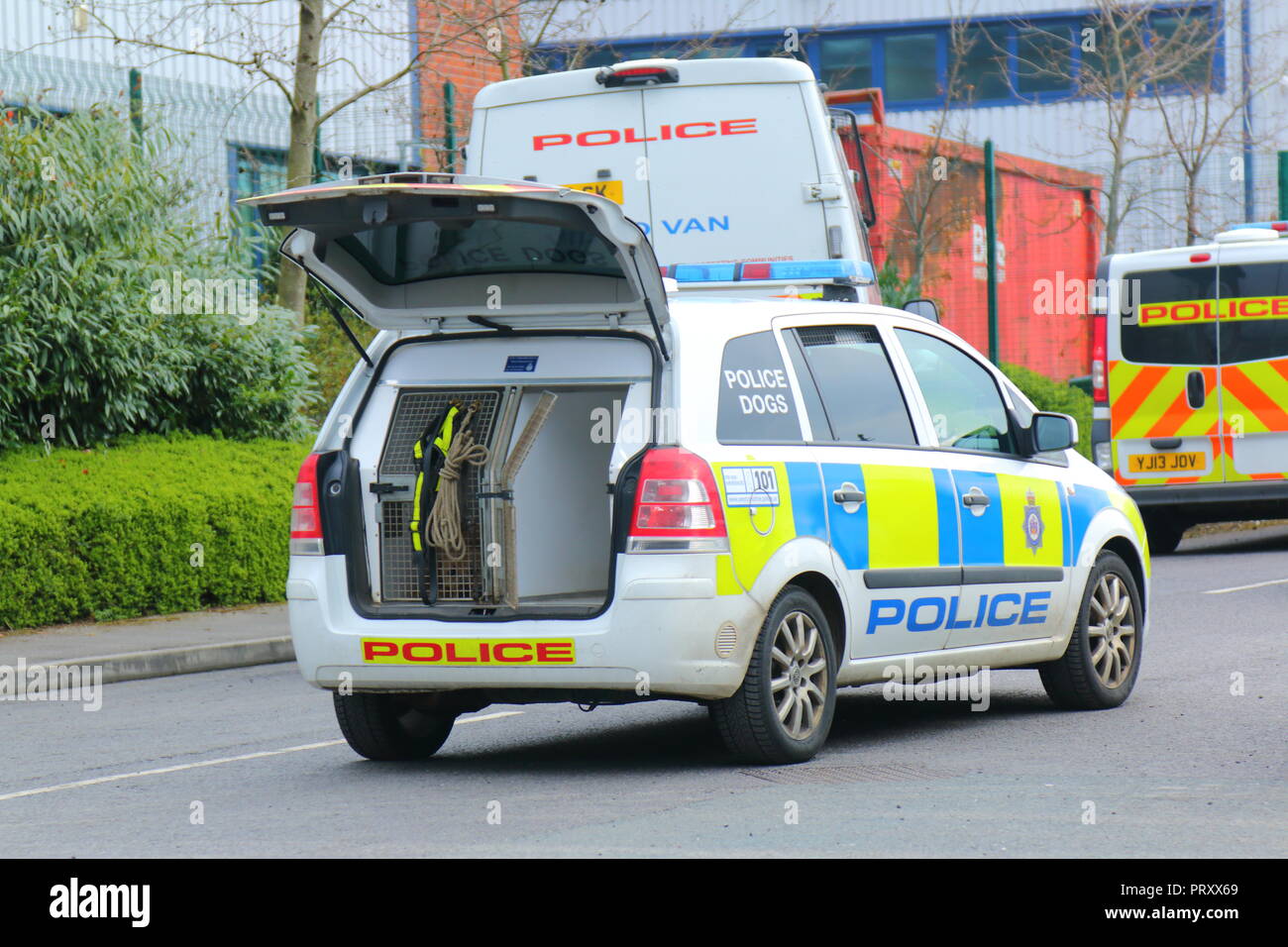 Police vehicles attending a crime scene , where the suspect was thought to be hiding in an industrial area of Garforth,West Yorkshire. Stock Photo