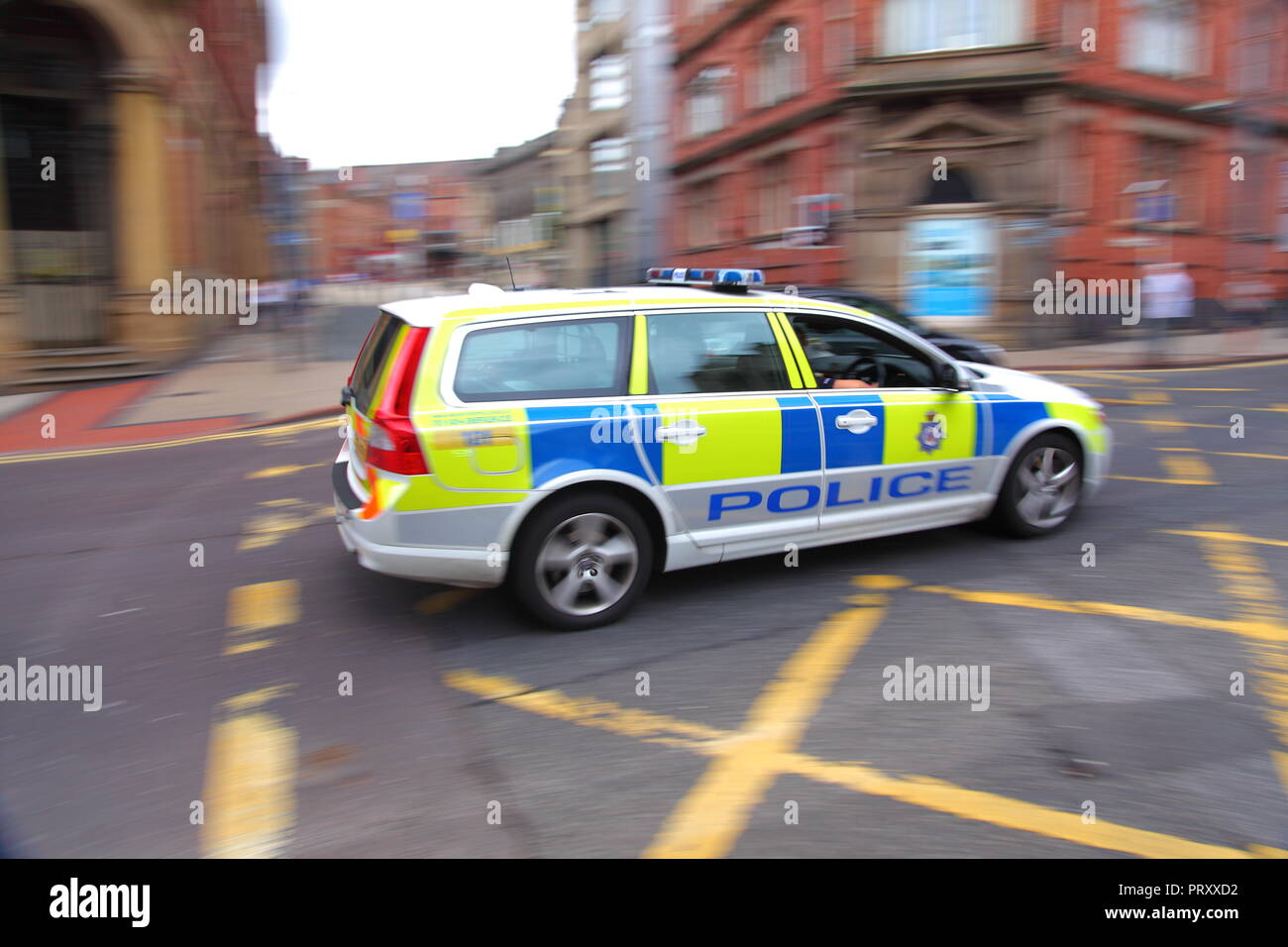 A police car speeds along Boar Lane, in Leeds City Centre. Stock Photo