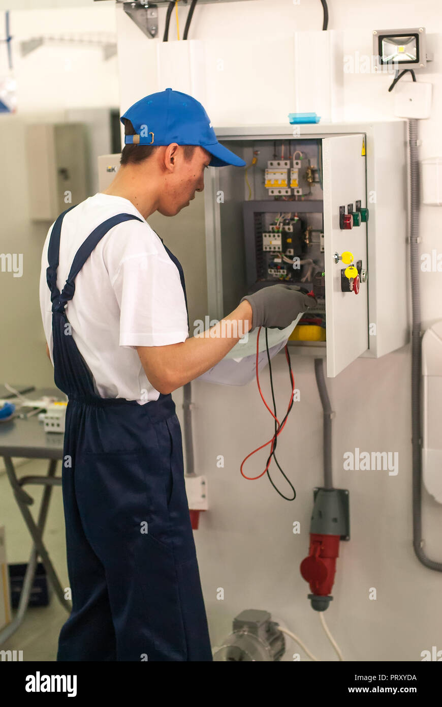 Tyumen, Russia - March 24. 2016: Open championship of professional skill among youth. World skills Russia Tyumen - 2016. Young electrician performs a  Stock Photo