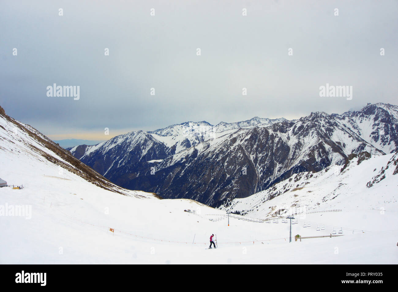 high snowy mountains in cloudy day, mounting skiing resort Shymbulak or Chimbulak, Almaty, Kazakhstan Stock Photo