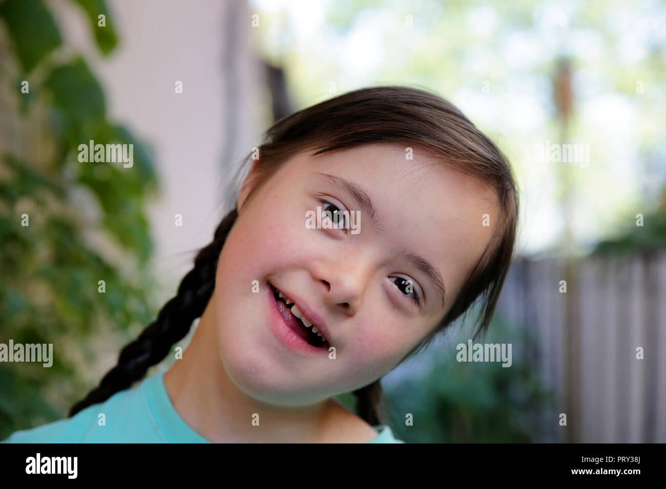Portrait of little girl smiling in the garden Stock Photo - Alamy