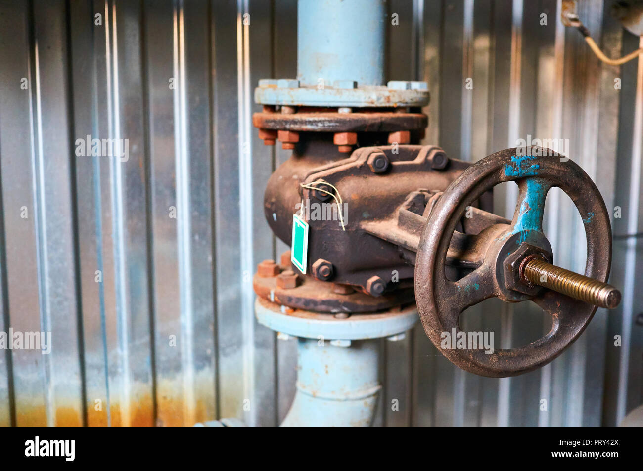 Old valves on the cold water pipeline. Industrial background. Stock Photo