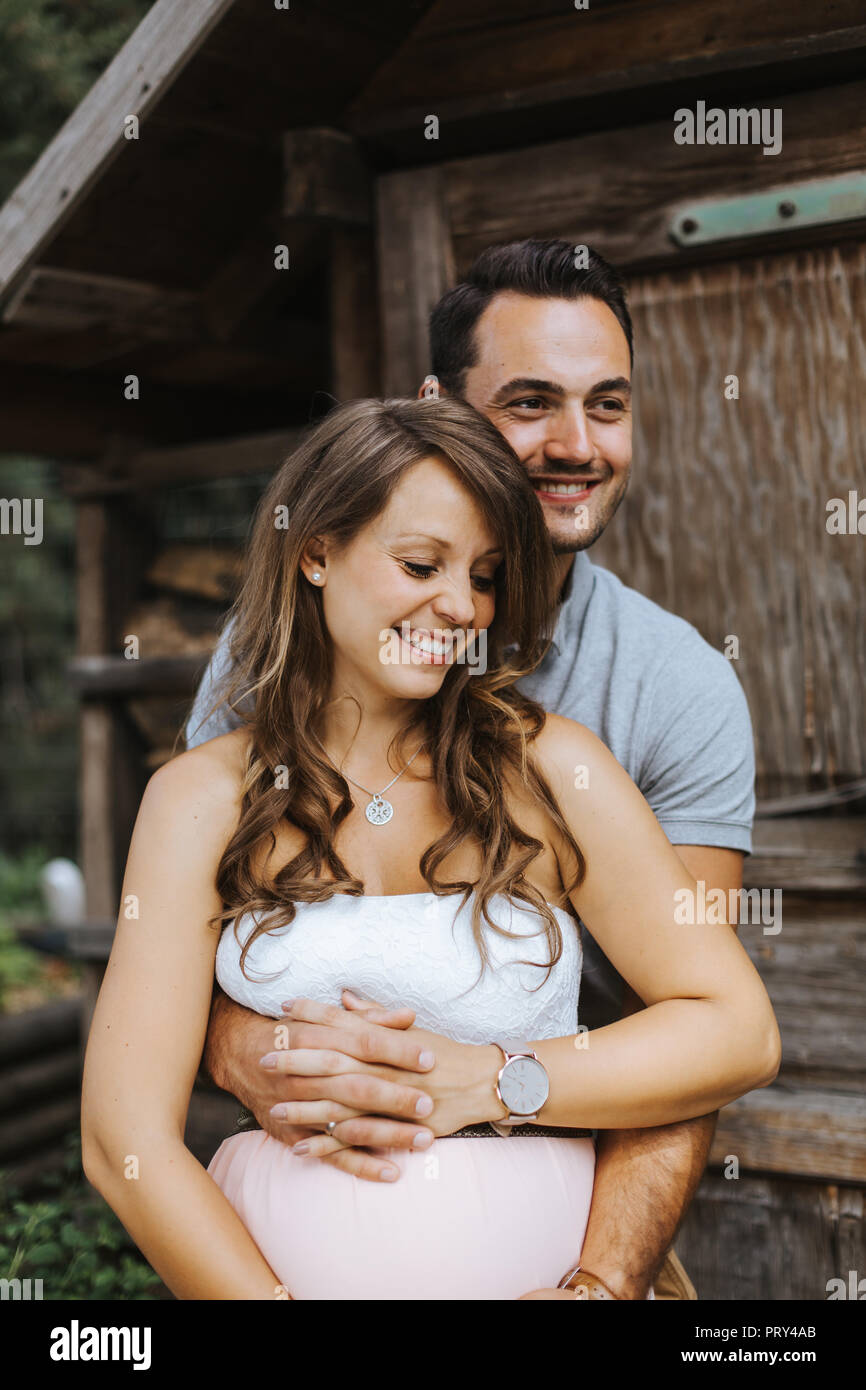portrait of pregnant wife and her husband smiling Stock Photo Alamy