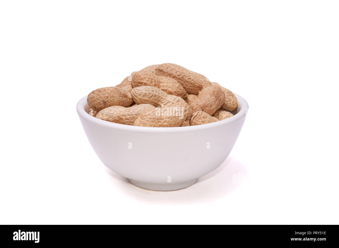 Peanuts in a white cup on a white background Stock Photo