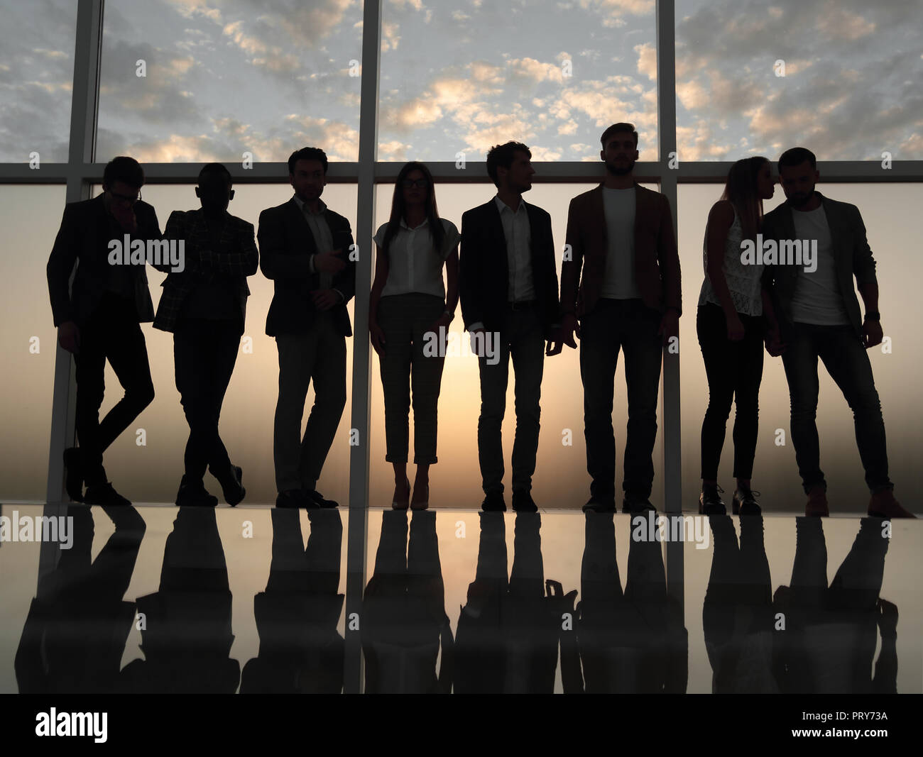 silhouette of a business team standing next to the office window Stock ...