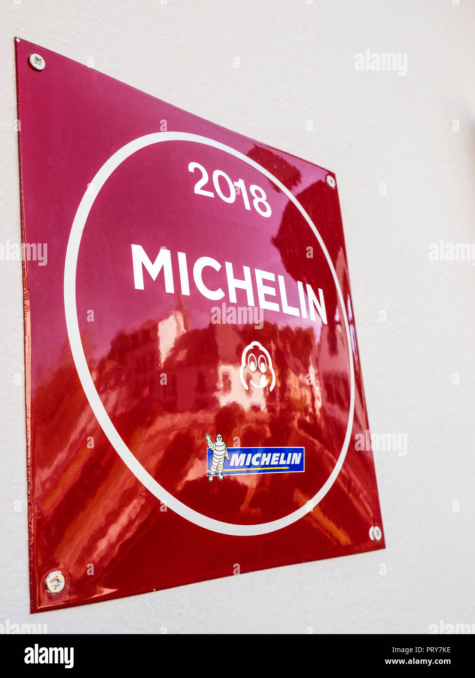 2018 Michelin Restaurant Guide Bib Gourmand Plaque at Sur le Pont restaurant with Bretagne village of Pont Aven reflected Brittany Finistere France Stock Photo