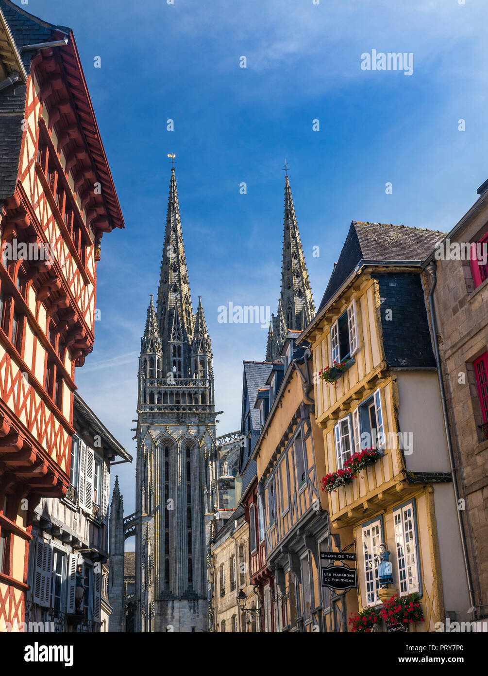 Quimper medieval half timbered old historic shopping quarter Cathedral spire in background Quimper Brittany  France Stock Photo
