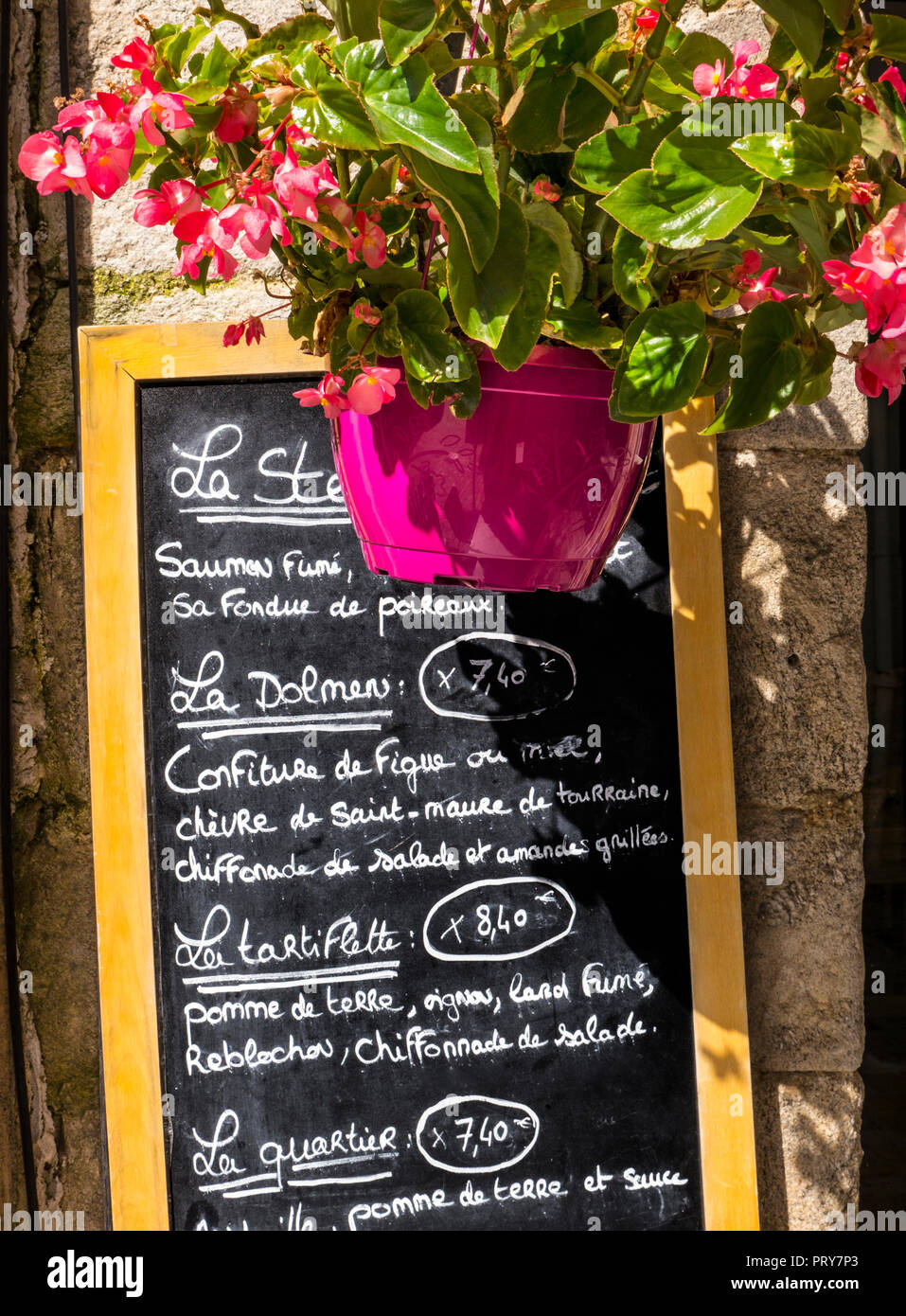 BLACKBOARD MENU FRANCE Blackboard menu specials of the day ‘PLAT DU JOUR’ outside rustic Brittany restaurant with flowers Bretagne Finistere France Stock Photo