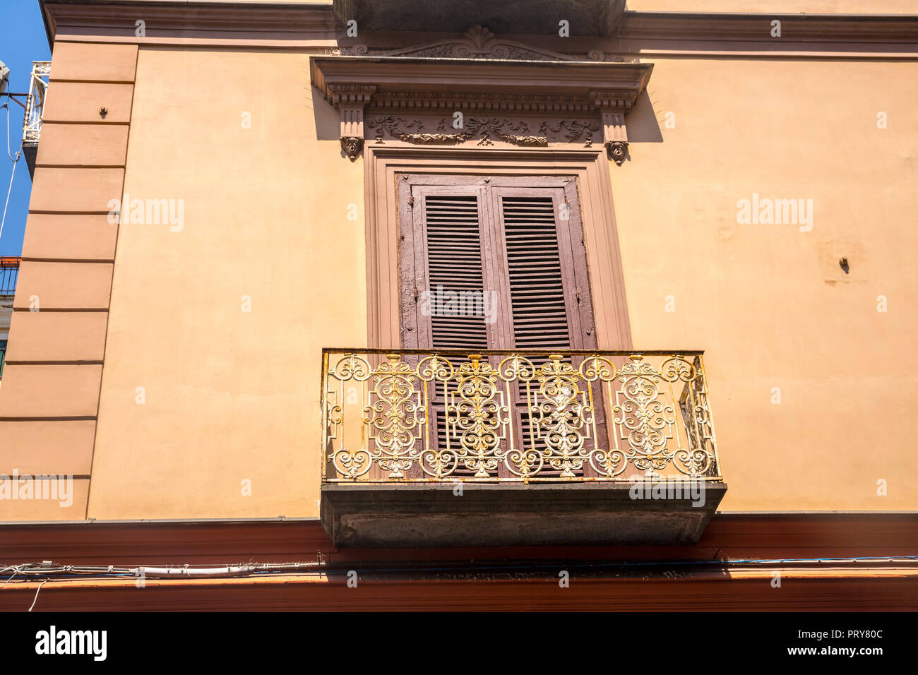 Italian buildings, wooden shutters, balcony, balconies, verandah, old fashioned, vintage concept, travel tourism, holiday, travelling ornate iron Stock Photo