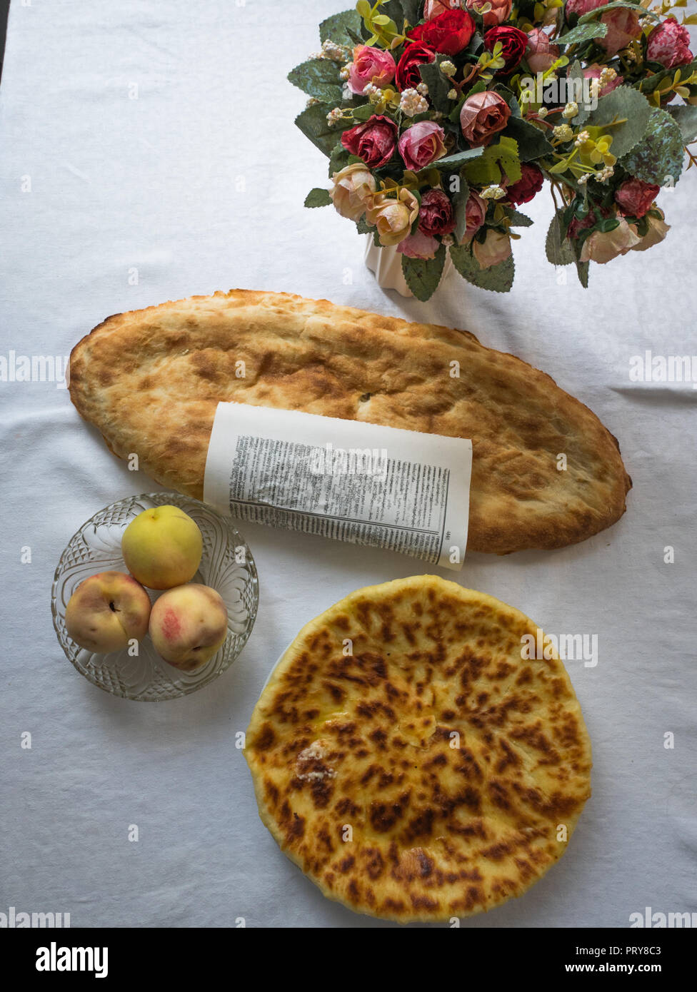 Khachapuri laid on a table. It is a traditional Georgian bread filled with different cheeses and styles can vary by region. Stock Photo