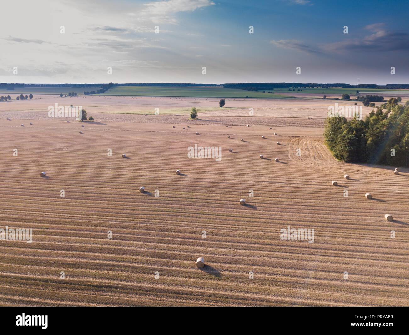 Aerial: stubble field with straw bales at late summer. Polish landscape ...