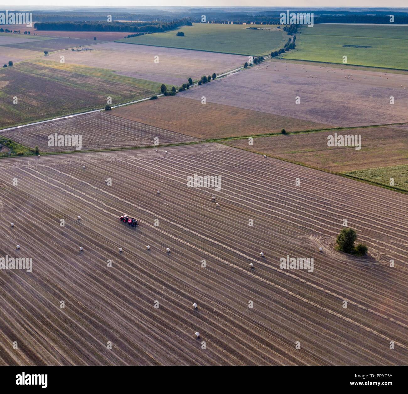 Aerial: stubble field with straw bales at late summer. Polish landscape ...