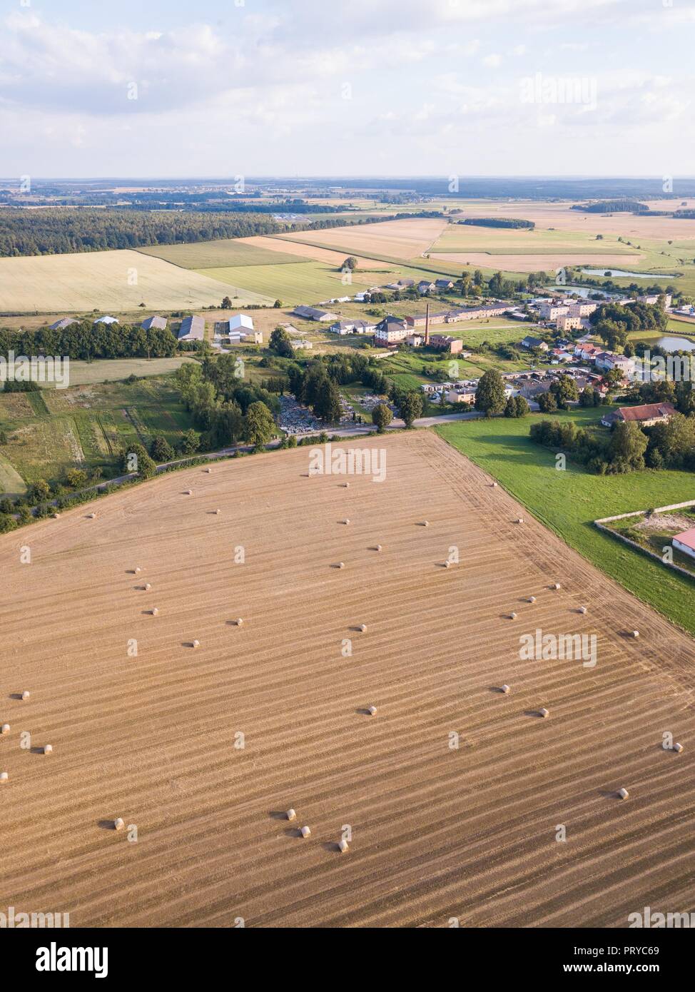Aerial: stubble field with straw bales at late summer. Polish landscape ...