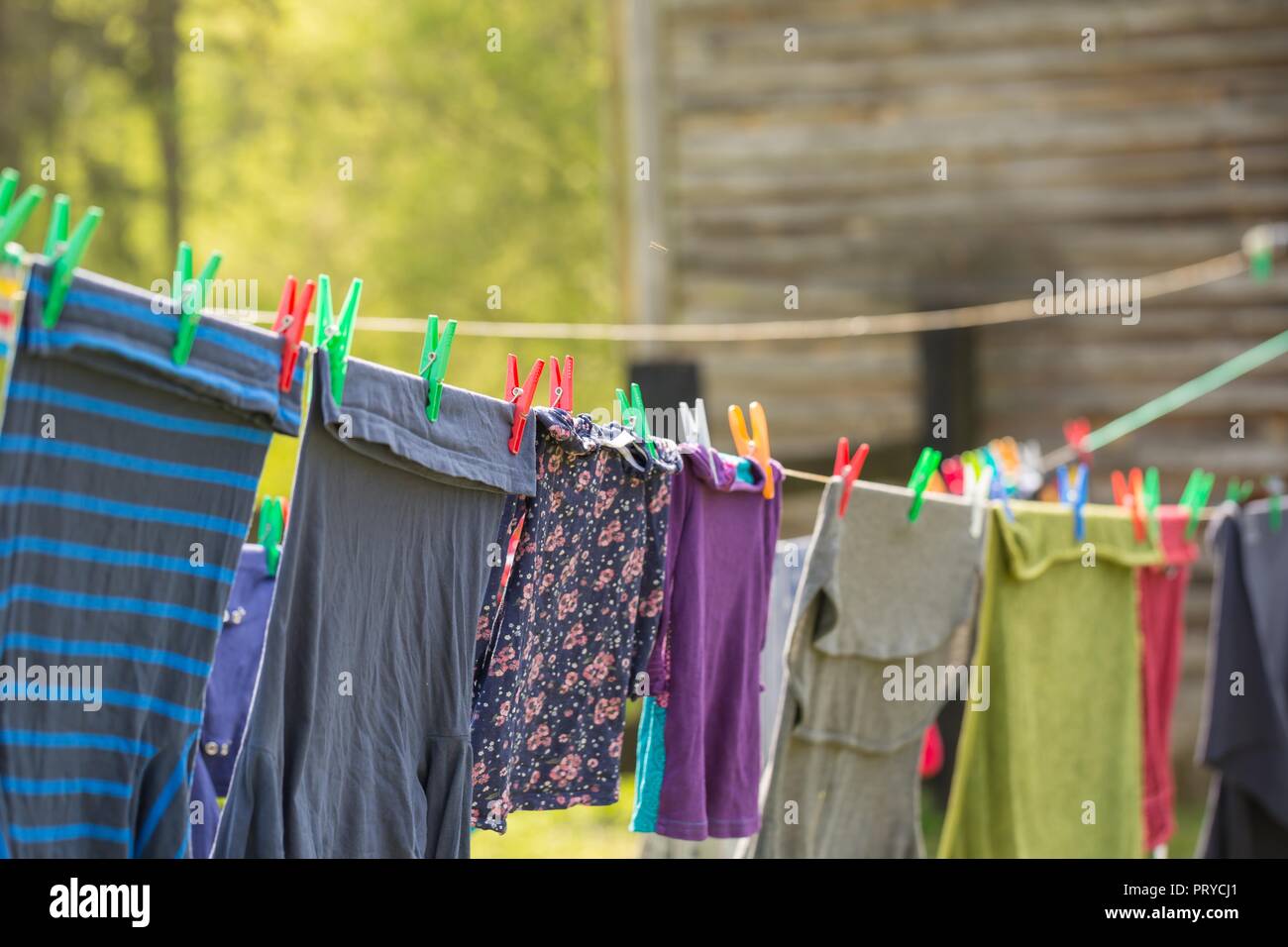 Washing line with drying clothes in outdoor. Clothes hanging on washing  line in outdoor Stock Photo - Alamy