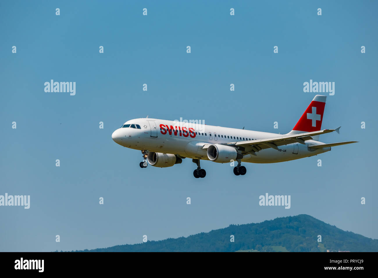 Swiss airlines airplane preparing for landing at day time in international airport Stock Photo
