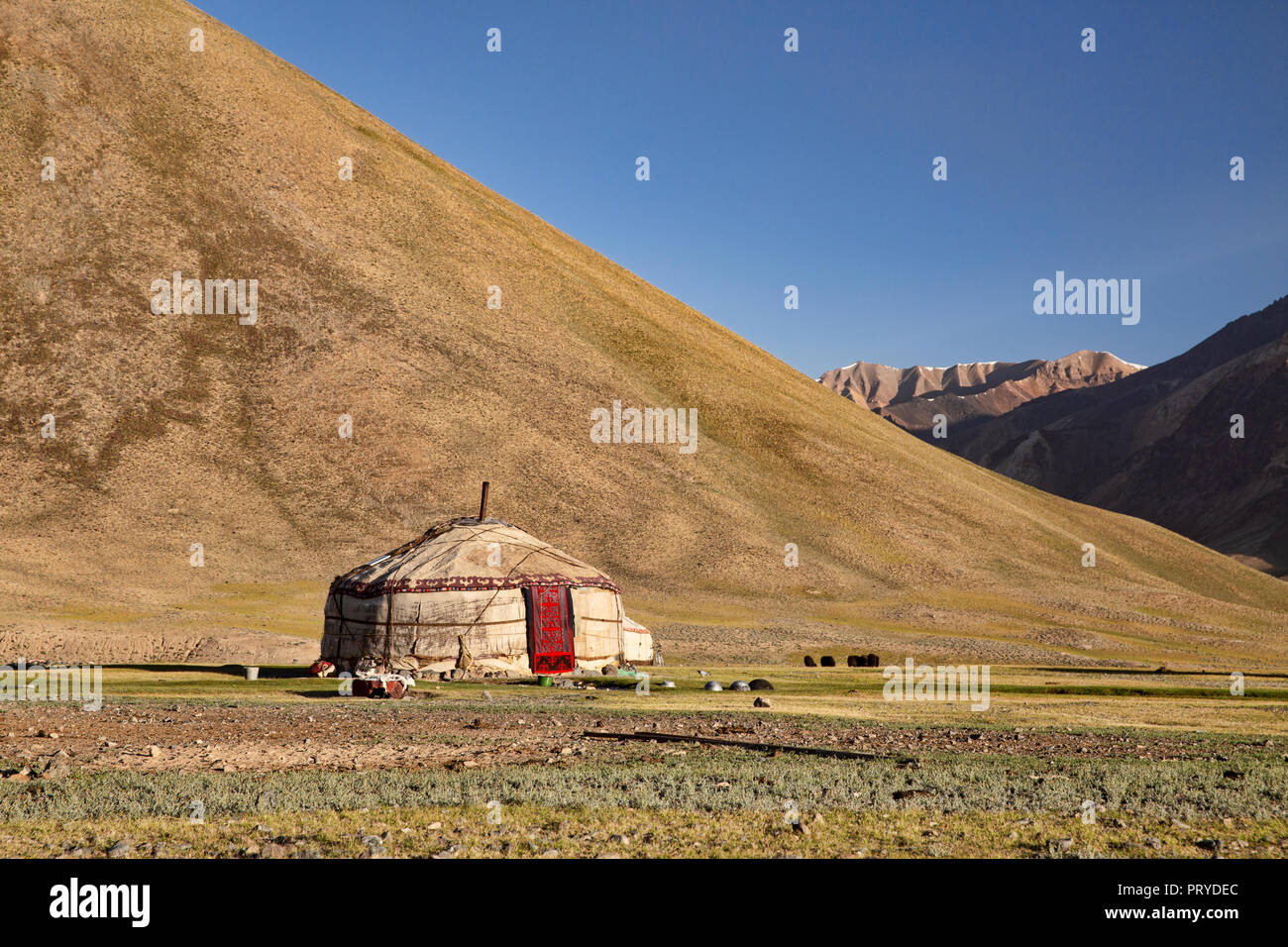 Kyrgyz yurt at sunrise golden hour in the remote Pshart Valley in the Pamir Mountains, Gorno-Badakhshan Autonomous Region, Tajikistan. Stock Photo
