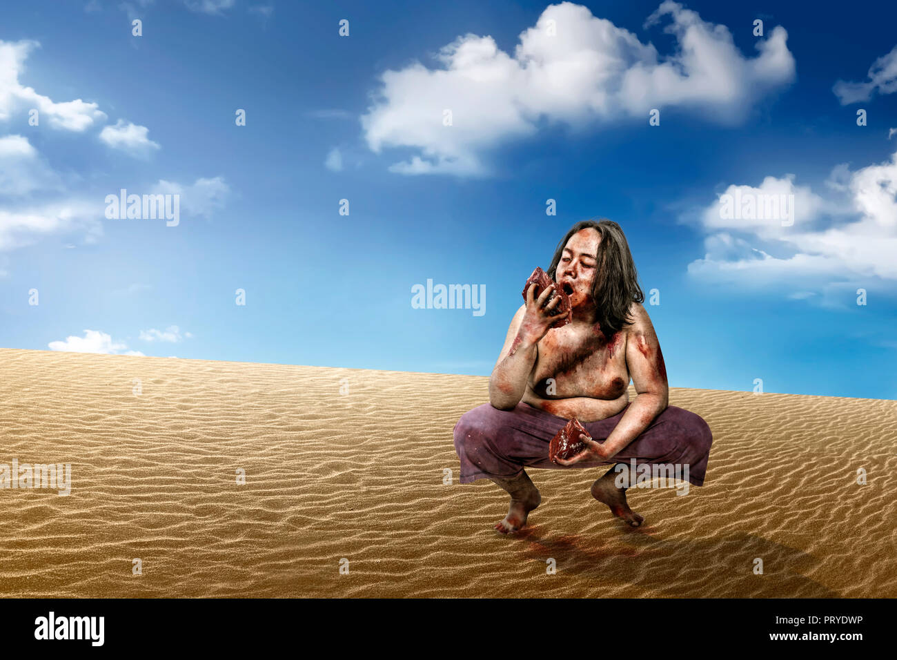 Scary zombie man eat the raw meat at desert Stock Photo Alamy